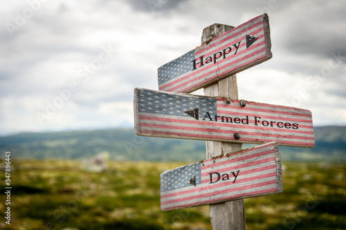 Happy armed forces day text on wooden american flag signpost outdoors in nature.