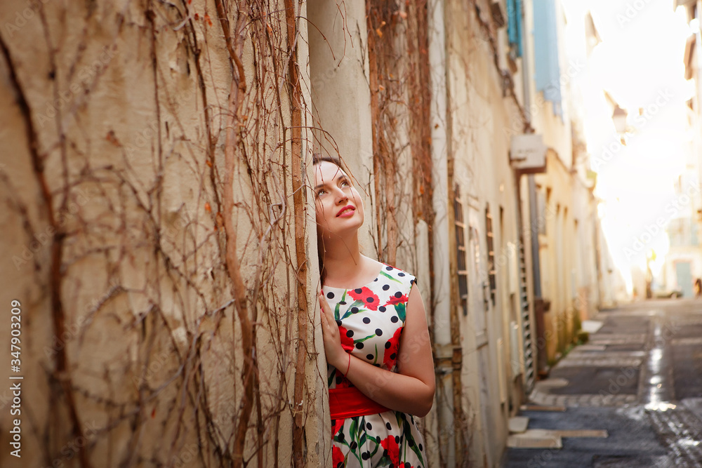 girl in narrow street in European provincial town.