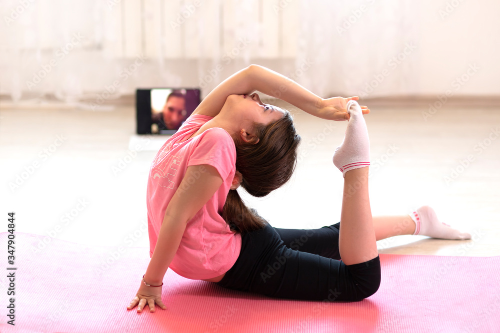 Fitness workout at home watching videos online working on laptop computer Fitness workout at home watching videos online working on laptop computer