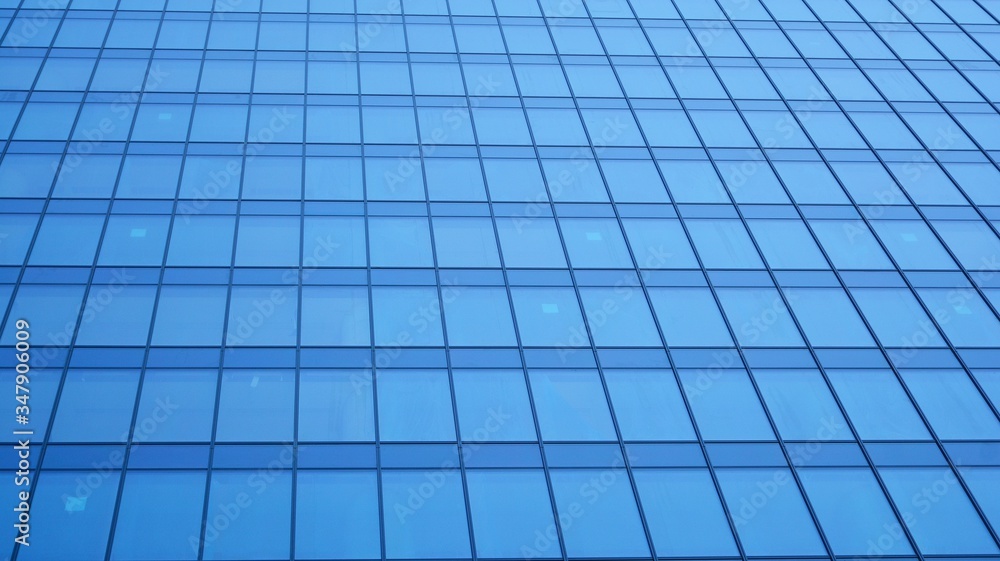 Modern architecture. Glass facade on the blue sky. Corporate concept - detail of modern glass building. Modern architecture. Glass facade on the blue sky. Corporate concept - detail of modern glass building.