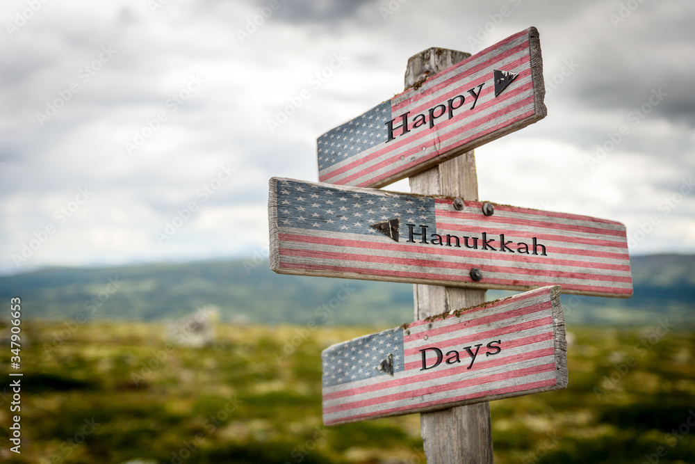 Happy hanukkah days text on wooden american flag signpost outdoors in nature.