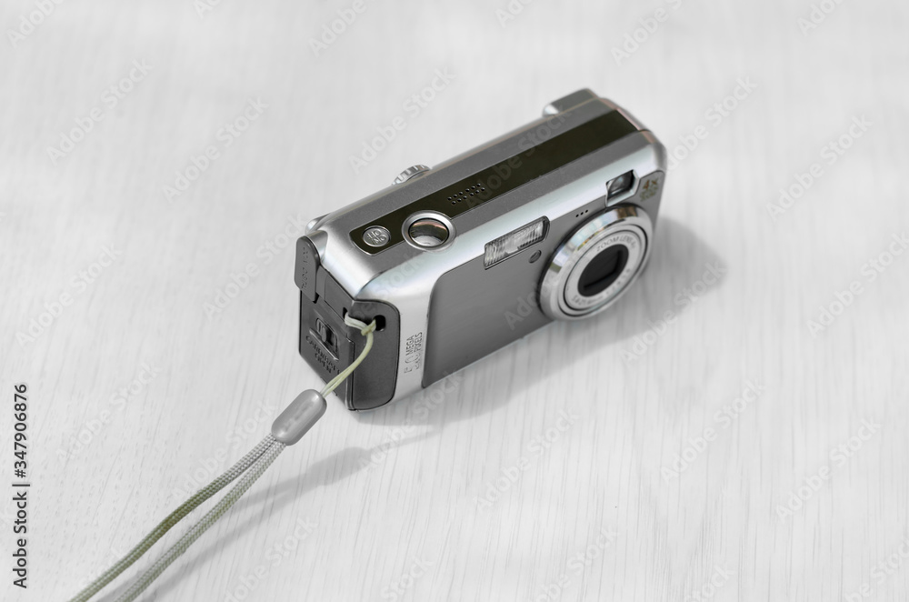 Old digital camera. The small camera is silver. Old digital camera. The small camera is silver.