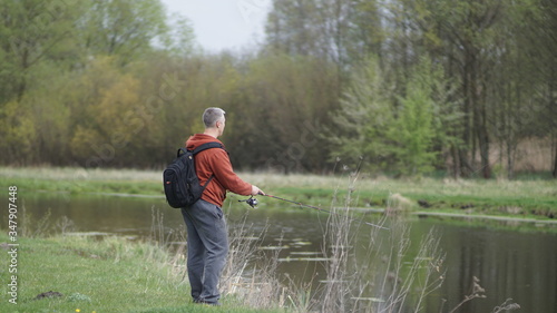 fishing man in a beautiful place in the meadow, spring