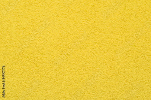yellow structural wall . yellow background . exterior plaster of the house