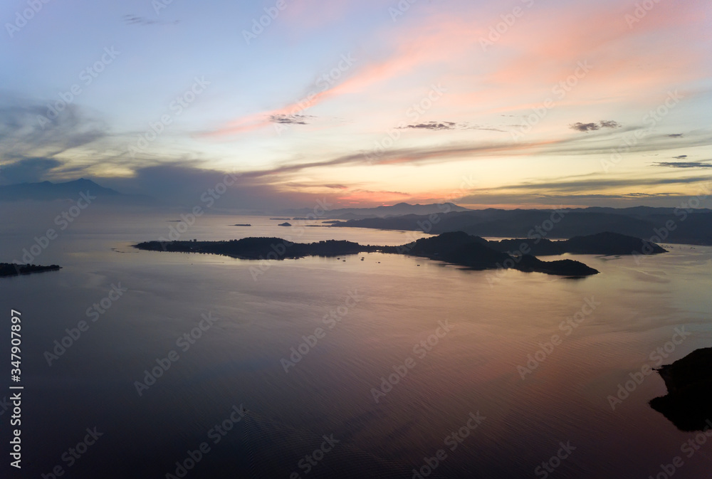 Lombok, Indonesia, south Gili islands. Aerial drone view on  silhouette of  hills Gili Gide island in the sea at sunset..