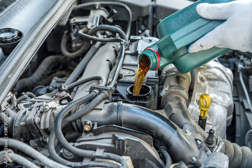 mechanic change oil to engine, car servicing © RomanR