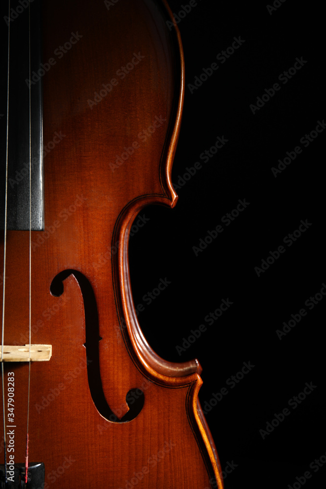 Classic violin on black background, closeup view Classic violin on black background, closeup view