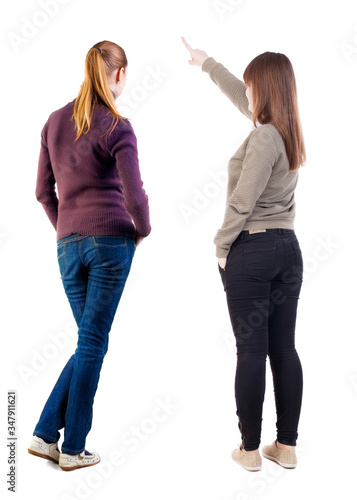 Back view of two pointing girl in sweater.