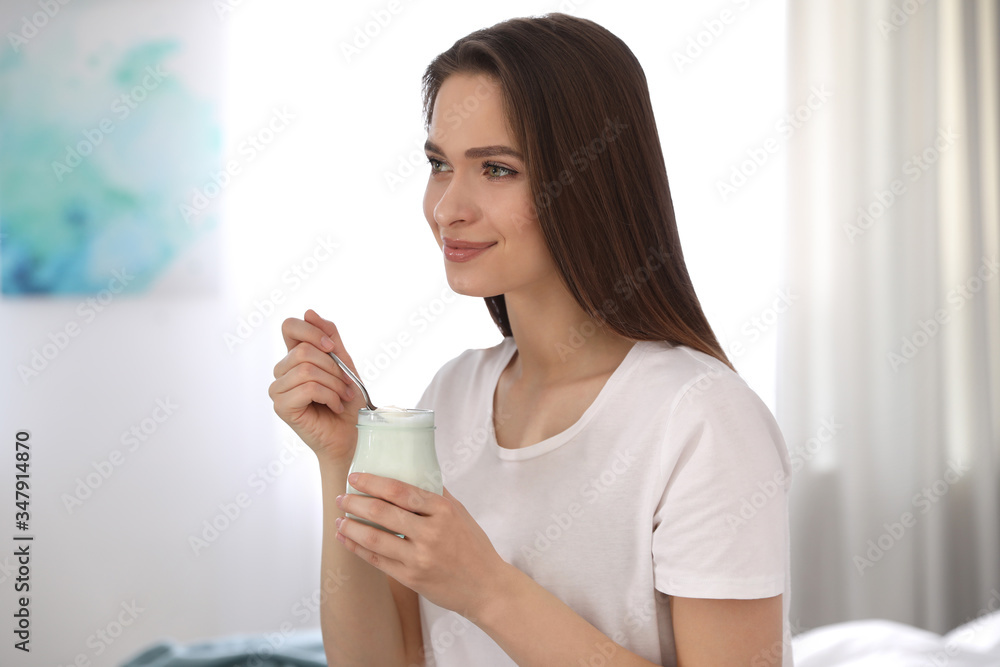 Young attractive woman with tasty yogurt at home Young attractive woman with tasty yogurt at home