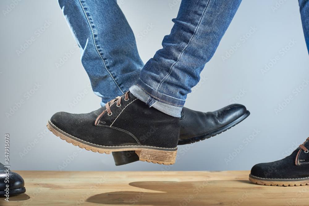 Feet bump. New greeting to avoid the spread of coronavirus. Two people ...