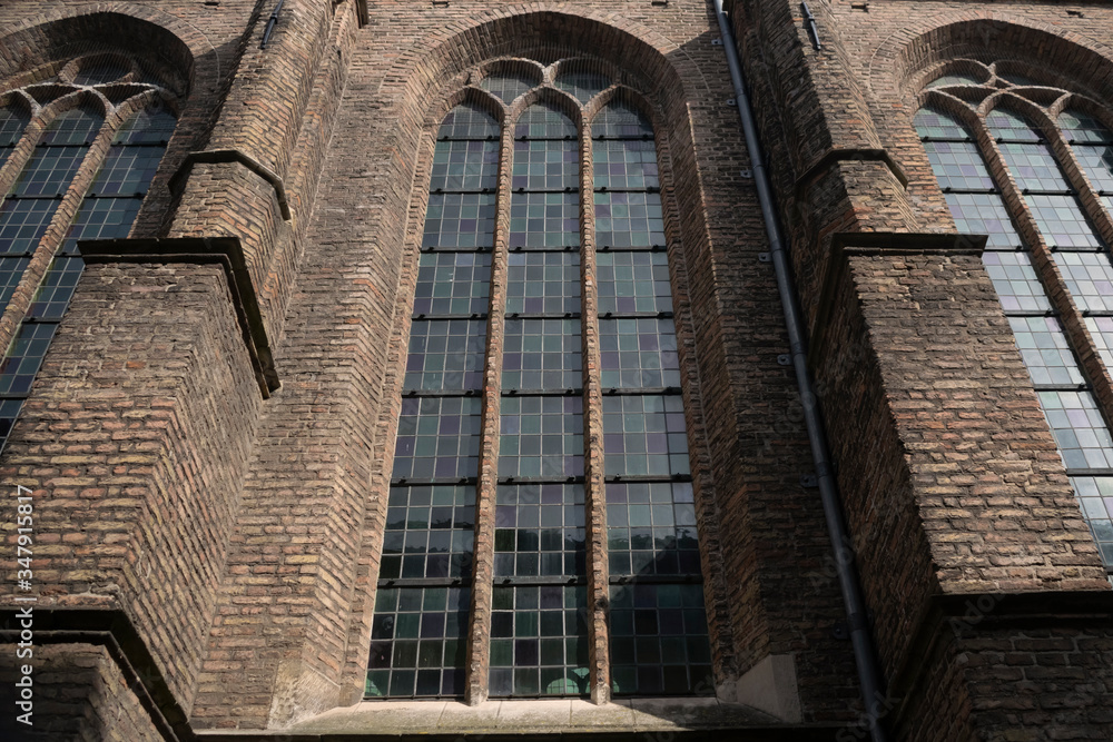 Detail of medieval wall of Old Church in historic city center of Delft, Netherlands. Travel or tourist abstract  background. 