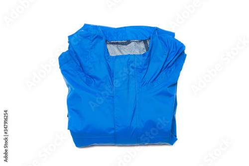 Folded blue zipper windbreaker jacket, rain proof and waterproof hiking Gore-Tex jacket hoodie. Track jacket sport nylon full zip isolated on white. Folded clothes. Outer layer garment for travel.