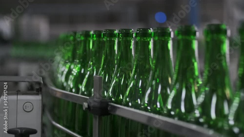 Wine bottles moving along a conveyor belt in a wine bottling factory. Manufacture of wine bottle. Glass recycling. Bottle manufacturing industrial factory. sparkle and still wines . prores HQ