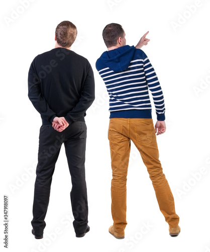 Back view of two man in sweater pointing.