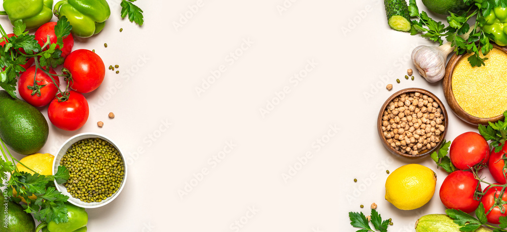 Food background. Frame of various vegetables, chickpeas, mung bean and polenta on a white background, top view. Vegetarian and vegan food, arabic cuisine. Flat lay, copy space, banner. Food background. Frame of various vegetables, chickpeas, mung bean and polenta on a white background, top view. Vegetarian and vegan food, arabic cuisine. Flat lay, copy space, banner.