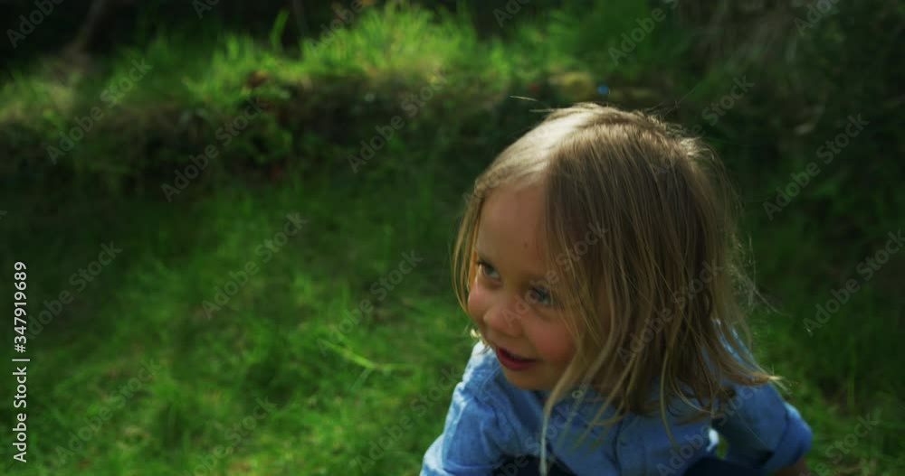 Little preschooler boy on lawn getting up to chase bubbles Little preschooler boy on lawn getting up to chase bubbles