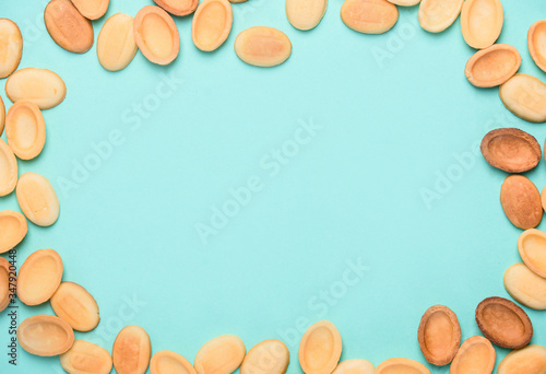 Homemade nuts with condensed milk, chocolate inside, walnuts and almonds. Nuts on a light blue background. A place for text.