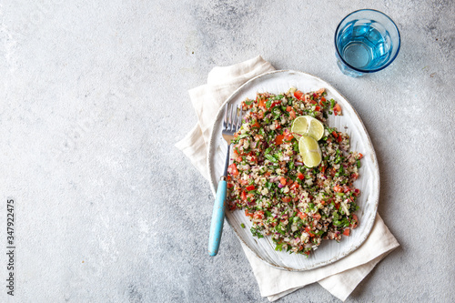 фотографія Quinoa Quinua salad with tomatoes and herbs in white bowl