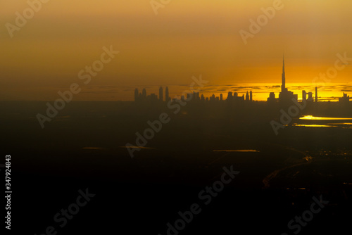 Low key contrasty beautiful aerial view of Dubai skyline with view over the Arabian Gulf during a sunset.