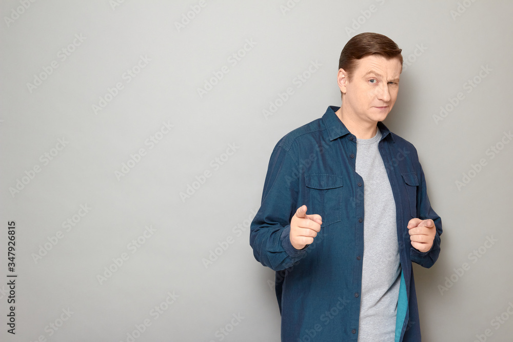 Portrait of happy confident mature man pointing with fingers at you Portrait of happy confident mature man pointing with fingers at you