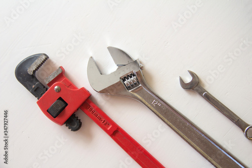Male tools. close up Happy Father's Day inscription with Mechanic hand hold spanner tool on white background. Greetings and presents. white card with the ability to insert text, copyspace, 