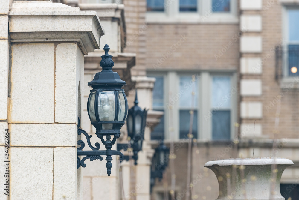 Decorative vintage old style street light Lanterns mounted on the building walls.