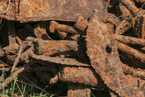 Ecology and recycling. Rusty scrap metal in a landfill in natural light. Details of cars, mechanisms.