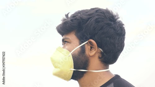 Indian man in yellow protective mask
