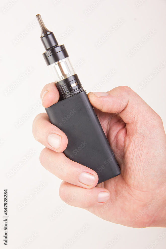 Electronic Cigarette Vape in the Hand of a Male Electronic Cigarette Vape in the Hand of a Male