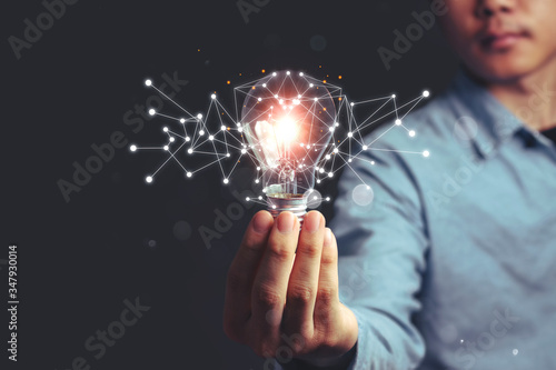 Asian Men holding light bulbs, ideas of new ideas with innovative technology and creativity. concept creativity, Branch with bulbs that shine glitter.