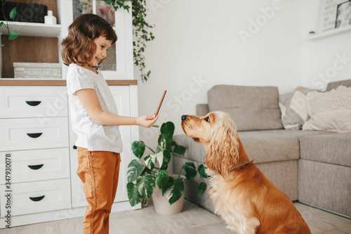 Cute little girl with dog at home