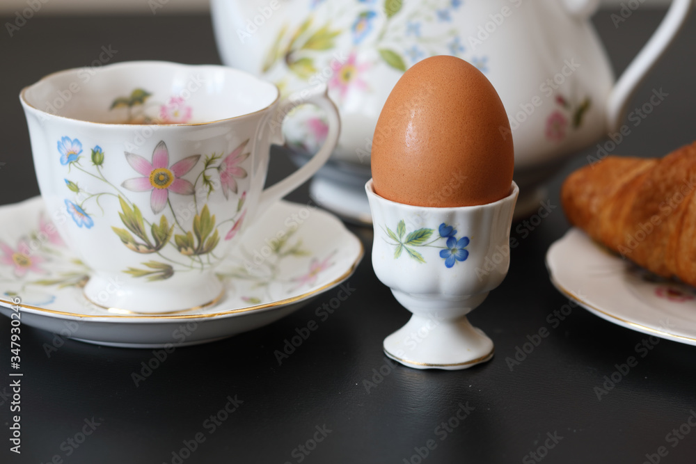 Continental breakfast with a teapot on a black table Continental breakfast with a teapot on a black table