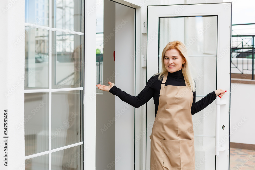 Half length portrait of waitress dressed in apron with copy space for brand name open store starting work ready to serve visitors, woman entrepreneur barista standing at restaurant entrance