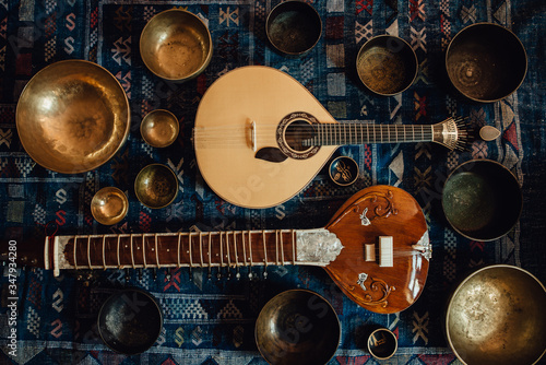 Traditional instruments: sitar and portuguese guitar and singing bowls photo