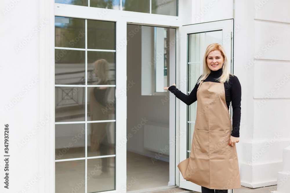 Half length portrait of waitress dressed in apron with copy space for brand name open store starting work ready to serve visitors, woman entrepreneur barista standing at restaurant entrance Half length portrait of waitress dressed in apron with copy space for brand name open store starting work ready to serve visitors, woman entrepreneur barista standing at restaurant entrance