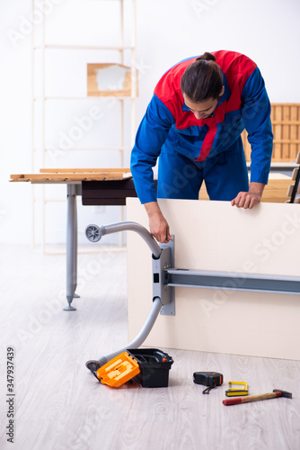 Young male contractor working in workshop © Elnur