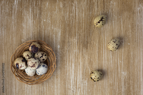 Top view of quail eggs on the wooden background