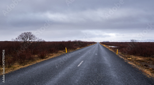 Empty road leading to the snowy mountains at snaefelness peninsula in Iceland