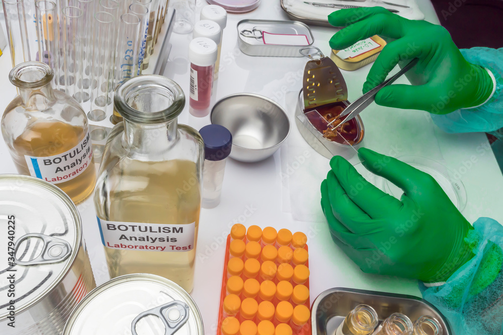 Experienced laboratory scientist analyzing a sample from a canned food can, botulism infection in sick people, conceptual image Experienced laboratory scientist analyzing a sample from a canned food can, botulism infection in sick people, conceptual image
