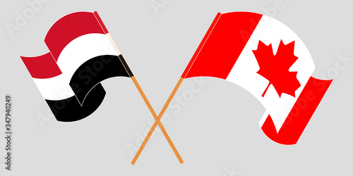 Crossed and waving flags of Yemen and Canada