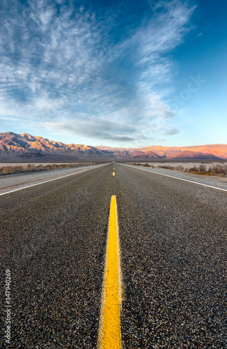 The road crossing the desert and going straight to the mountains.