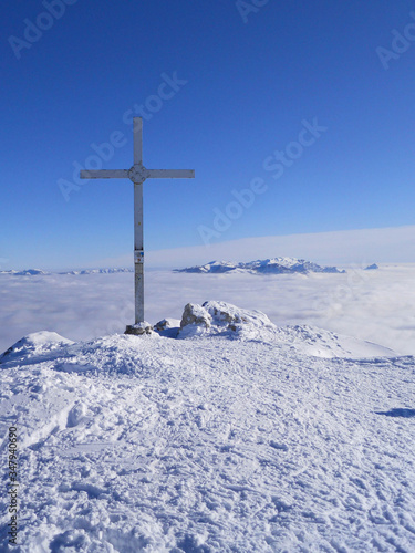 The cross on top of mount Stivo in the alps over the Garda lake