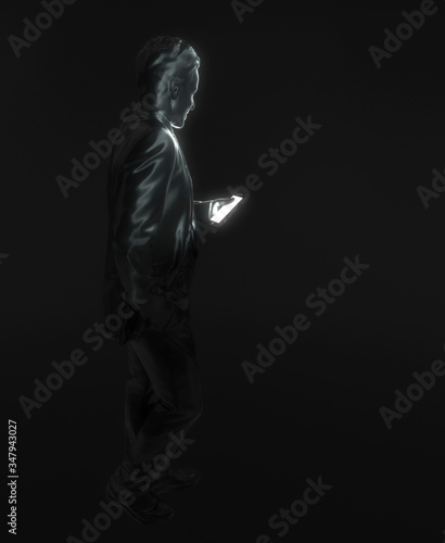 Human's figure holds a smartphone in his hand. A black statue of a man on a black background looks at the bright screen of a mobile phone. Modern gadget. Creative conceptual 3D rendering.