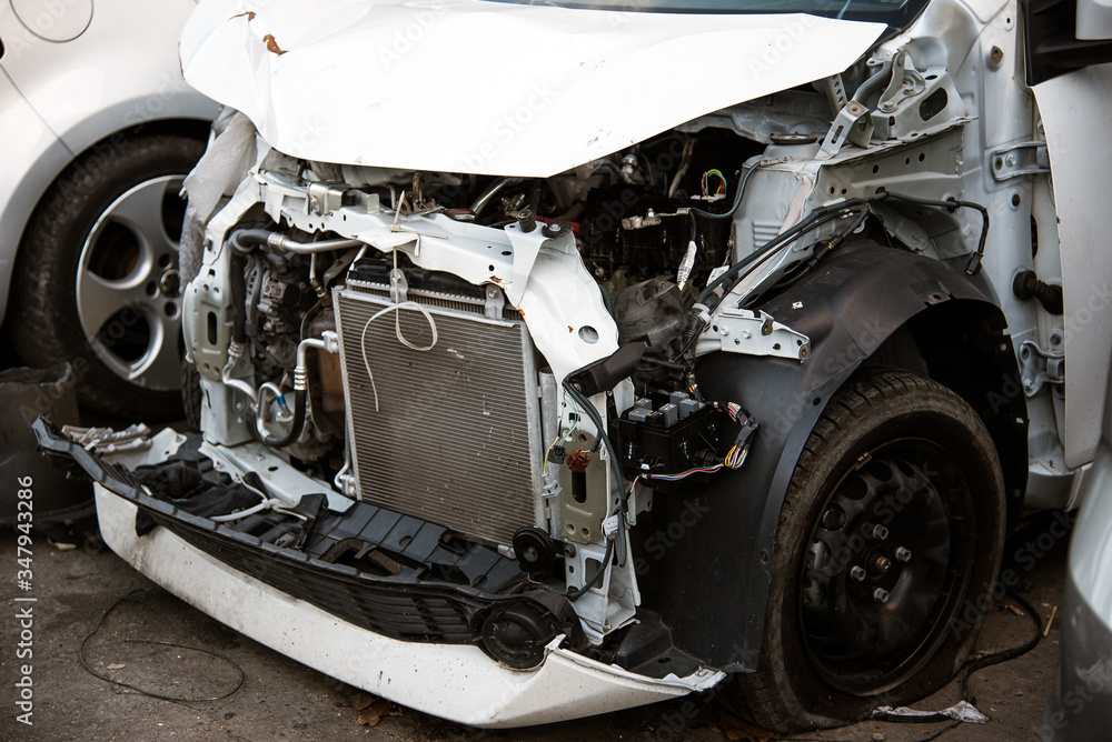 Crashed car without bumper and fenders Crashed car without bumper and fenders