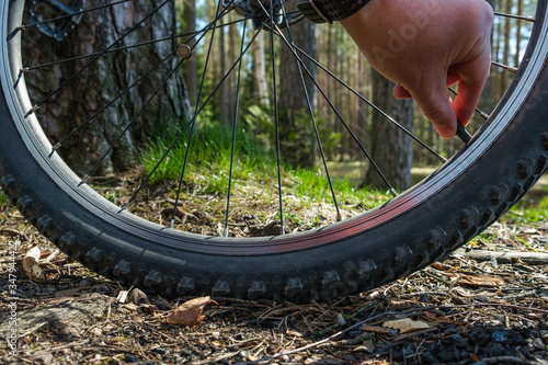 hand repair bicycle wheel travel crosscounty summer photo