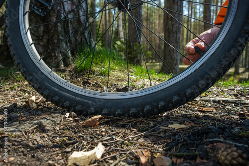 hand repair bicycle wheel travel crosscounty summer photo