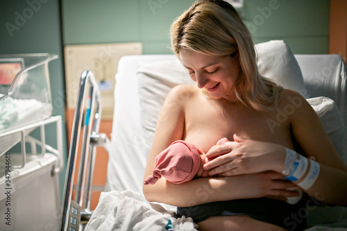 Billede på lærred Breastfeed Mother with her newborn baby at the hospital a day after a natural bi