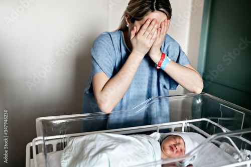 Fotografija Sad and depress Mother with her newborn baby at the hospital a day after a natur