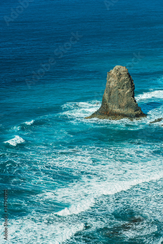 Viewpoint on Famous Benijo Rock with ocean waves crushing located at Benijo Beach seen from above, Tenerife, Spain.