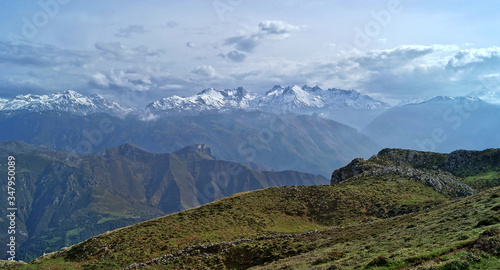 panoramic view from Sierra del Cuera mountains towards Picos de Europa in Asturias with dramatic cloud sky photo